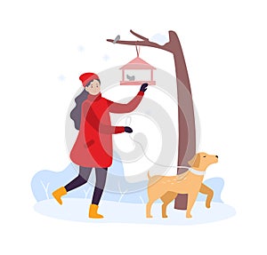 Winter activities. Girl walking with dog and feeding birds. Woman character in winter clothing with pet