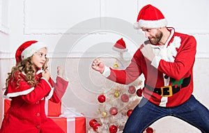 Winter activity and fun. Child pretend to fight for christmas gifts. Christmas games. Make it fun. Kid cute girl play