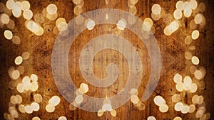 Winter / Advent / christmas Background template - Frame made of golden bokeh lights on brown wooden texture, top view with space