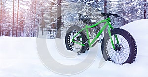 winter adventures - fat bike standing in the snow on snowy finland lapland forest background