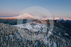 Winter aerial landscape of majestic Carpathian mountains. Background with sunset