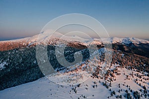 Winter aerial landscape of majestic Carpathian mountains. Background with sunset