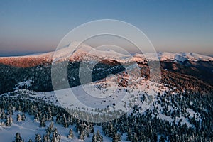 Winter aerial landscape of majestic Carpathian mountains. Background with sunset