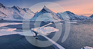 Winter aerial panorama over norwegian sea shore and Fredvang bridge, Reine, Lofoten islands, Norway video.