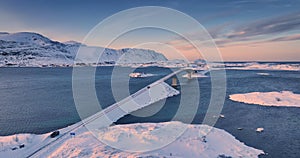 Winter aerial panorama over norwegian sea shore and Fredvang bridge, Reine, Lofoten islands, Norway video4K