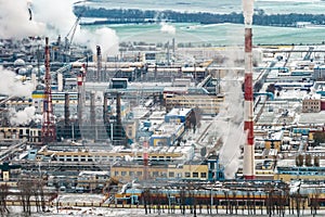 winter aerial panoramic view on smoke of pipes of chemical enterprise plant. Industrial landscape environmental pollution waste