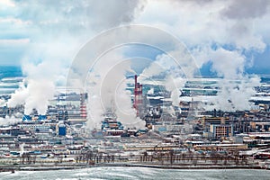 winter aerial panoramic view on smoke of pipes of chemical enterprise plant. Industrial landscape environmental pollution waste