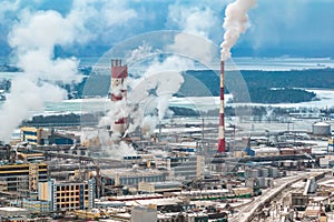 winter aerial panoramic view on smoke of pipes of chemical enterprise plant. Industrial landscape environmental pollution waste