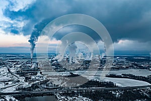 winter aerial panoramic view on smoke of pipes of chemical enterprise plant. Industrial landscape environmental pollution waste