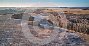 Winter Agricultural field under snow panorama. December Rural landscape