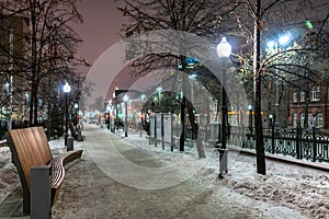 Winter alley in the heart of the city at night