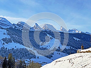 Winter alpine snow peaks of the Churfirsten mountain range between Lake Walenstadt or Lake Walen Walensee and the Thur valley