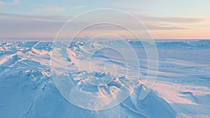 Winter arctic landscape. View of snow and ice at sunset. Ice hummocks on the frozen sea in the Arctic.