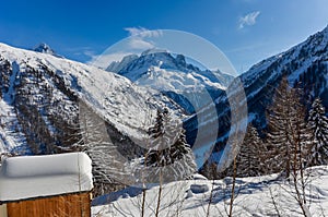 Winter aura in the Alps, beautiful view of the cottage - mountains, trees in snow, Mont Blanc du Tacul, Chamonix, France