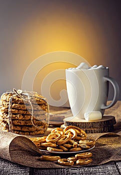 Winter autumn still life homemade recipe honey ginger oatmeal cookie and bagel, cocoa cup coffee with marshmallow on wooden table
