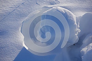 Winter background. Abstract. Snow drifts. Smooth transitions of lines of light and shadow. Snow on a sunny day