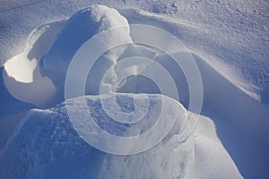 Winter background. Abstract. Snow drifts. Smooth transitions of lines of light and shadow. Snow on a sunny day