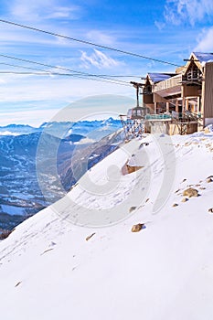 Winter background with cable car, mountain peaks