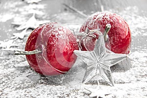 Winter background. Fallen defocused snowflakes. Christmas red balls