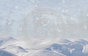 Winter background, falling snow over winter landscape