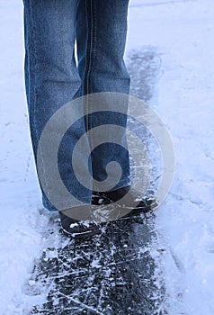Winter background - legs of girl on the ice