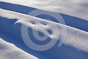 Winter background. Snow and bumps. Snow-covered track