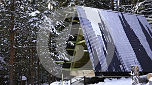 Winter background with snow. Clip. A beautiful landscape in the forest with a wooden hut under construction.