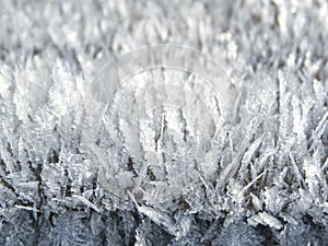 Winter background with snowflakes crystals patterns and snow on frozen grass