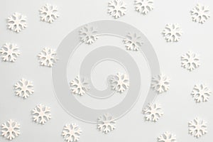 Winter background, white snowflakes over white board. Abstract Christmas winter texture photo