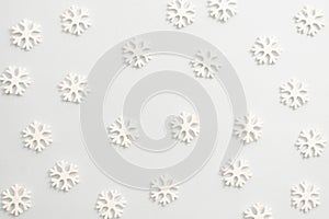Winter background, white snowflakes over white board. Abstract Christmas winter texture