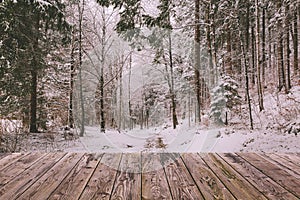 Winter background with wooden terrace and nature forest landscape. Christmas holiday concept