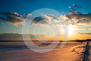 Winter Beach Scene with snow at sunset