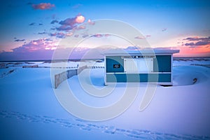 Winter Beach Scene with snow at sunset