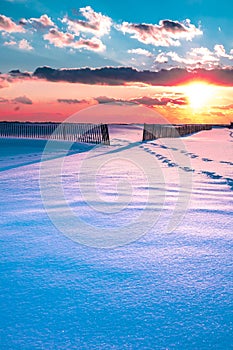 Winter Beach Scene with snow at sunset