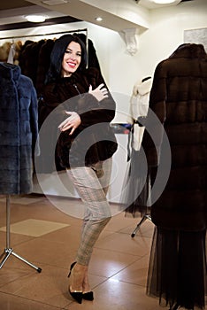 Winter beautiful Woman in Fur Coat. Beauty Fashion Model Girl In a Fur Store.