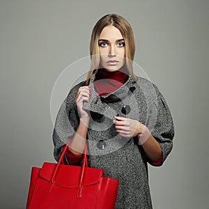 Winter beautiful Woman with Handbag.Beauty Fashion Girl in topcoat