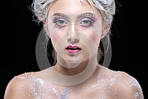 Winter Beauty Woman in clothes made of frozen flowers covered with frost, with snow on her face and shoulders. Christmas