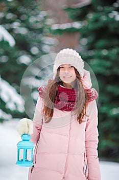 Winter beauty. Woman holding Christmas lantern outdoors on beautiful winter snow day