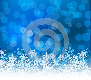 Winter blue bokeh xmas background with snowflakes. Christmas bokeh holiday decoration for greeting card