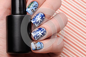 Winter blue manicure with shimmer and snowflakes pattern on red lines candy background