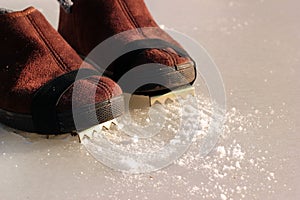 Winter boots with affixed ice cleats