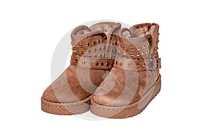 Winter boots for children. Close-up of a pair of elegant brown suede winter boots which are lined with fur. Girls winter shoe