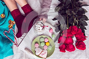 Winter breakfast in bed with red roses and heart of sugar candie