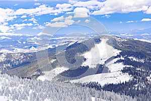 Winter bright nature mountains panorama on ski resort.Pine fir spruce trees covered with snow ice in forest in