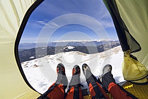 Winter camping in the mountains with a backpack and tent.