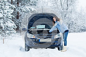 Winter car breakdown - woman call for help.