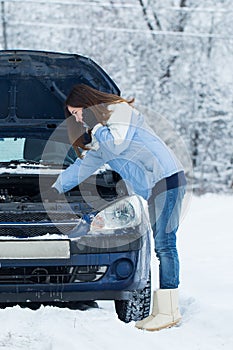 Winter car breakdown - woman call for help.