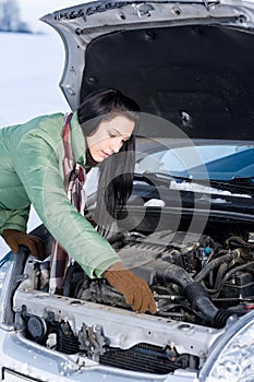 Winter car breakdown - woman repair motor