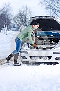 Winter car breakdown - woman repair motor