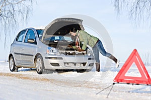 Winter car breakdown - woman repair motor